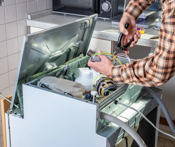 man repairing an appliance