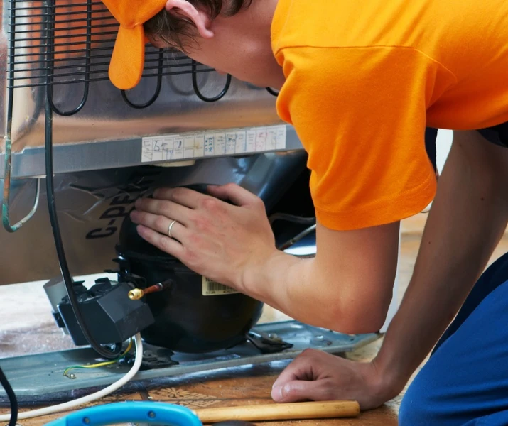 man repairing an appliance