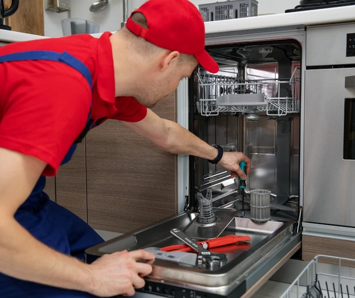 man repairing an appliance