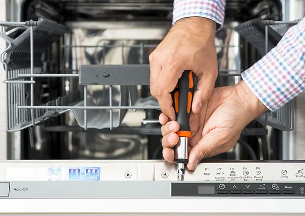 Man servicing a dishwasher