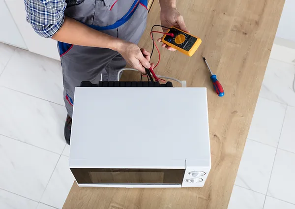 Man repairing a microwave