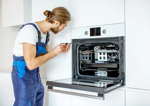 Man repairing an oven