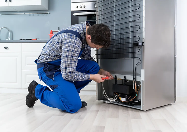 man repairing a refrigerator